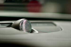 A close up of a speaker on a car dashboard — illustrative photography